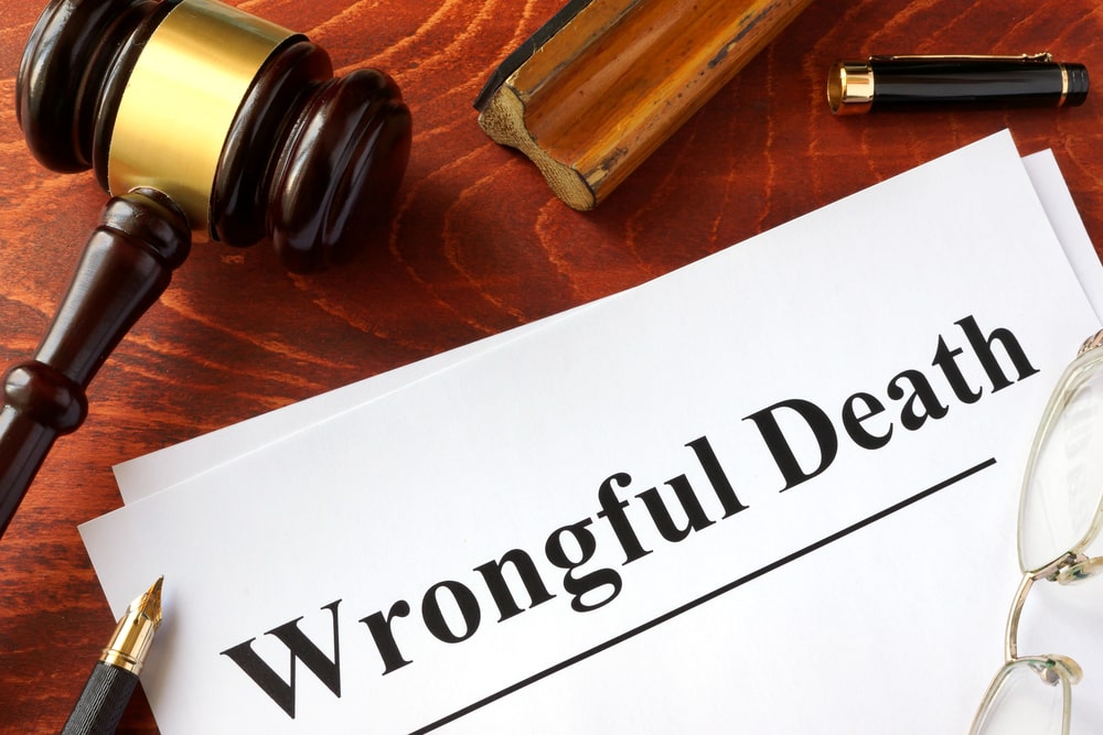 Wrongful death attorney reviewing legal documents with family member